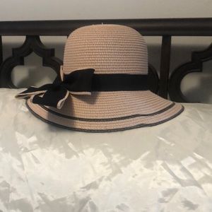 One size fits all pink hat with black bow accent